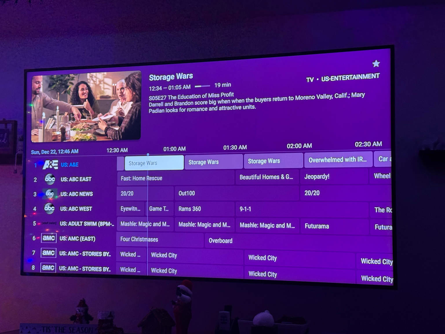 An Electronic Program Guide (EPG) from TiviMate displayed on a television screen, showcasing program listings and detailed show information.